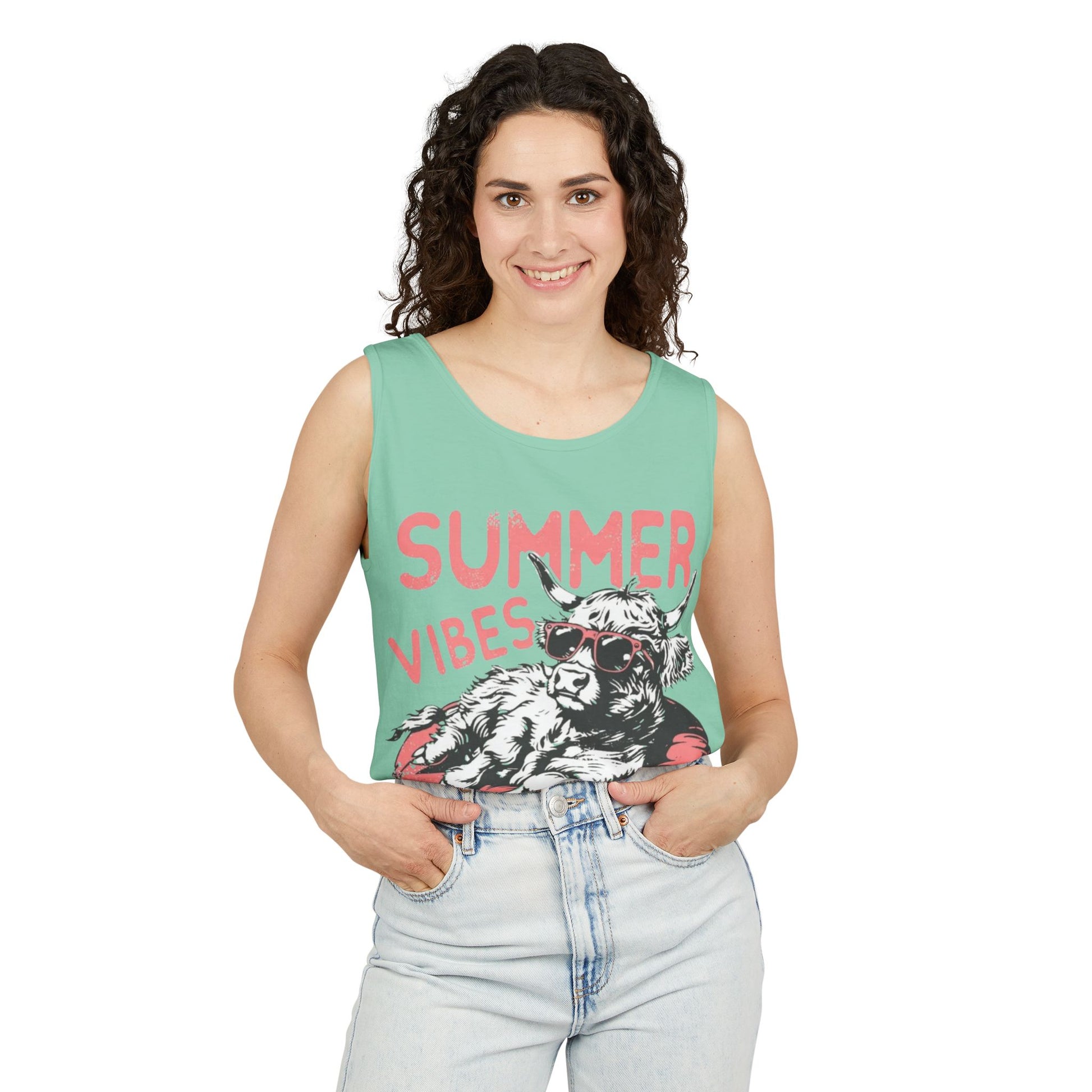 A woman wearing a sleeveless green tank top with a graphic design and the text "SUMMER VIBES" printed on it.