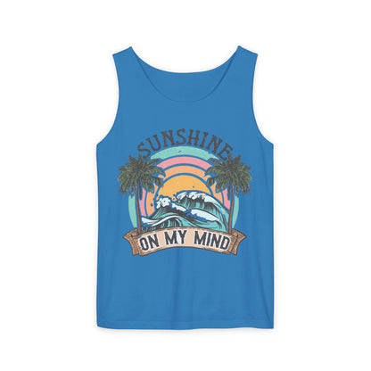 A blue tank top with a graphic design featuring a palm tree, a wave, and the text "SUNSHINE ON MY MIND"