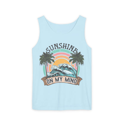 A light blue tank top with a graphic design featuring a palm tree, a wave, and the text "SUNSHINE ON MY MIND"