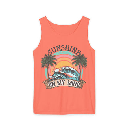The image is a bright orange tank top with a graphic design featuring a sunset, palm trees, and the text "SUNSHINE ON MY MIND".