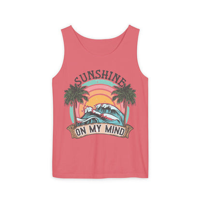 A pink tank top with a graphic design featuring a sunset, palm trees, and the text "SUNSHINE ON MY MIND".