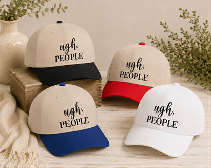 four baseball caps with the text "ugh. PEOPLE" printed on them, arranged on a wooden surface.
