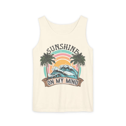 A white tank top with a graphic design featuring a sunset, palm trees, and the text "SUNSHINE ON MY MIND".
