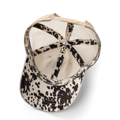 the inside of a baseball cap with a spotted pattern, revealing the mesh lining and the brim.
