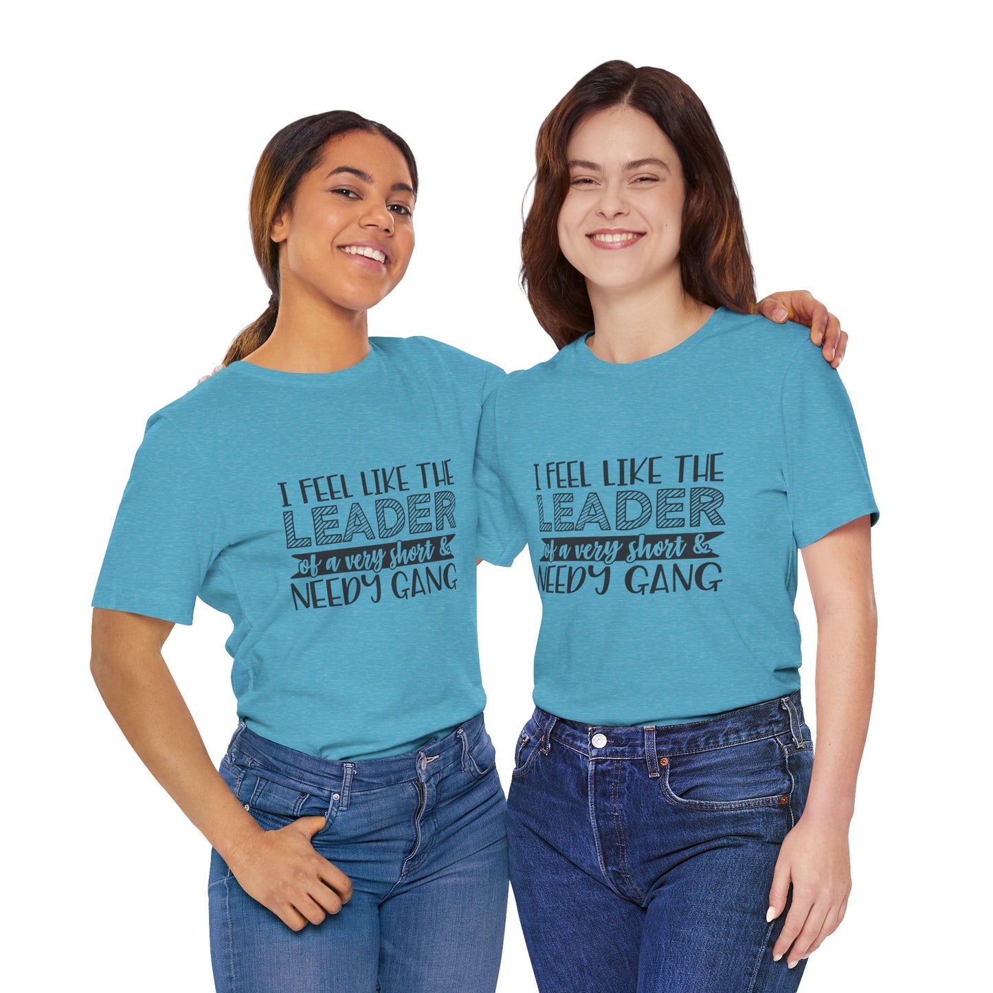 Two young women wearing matching teal t-shirts with text that says "I feel like the leader of a very short & very nice gang".