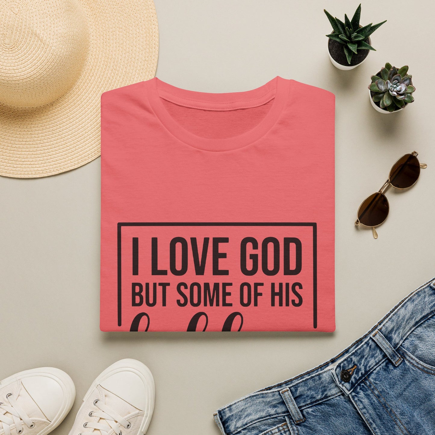 a casual outfit consisting of a red t-shirt with the text "I LOVE GOD BUT SOME OF HIS" printed on it, a pair of denim shorts, white sneakers, sunglasses, and a straw hat.