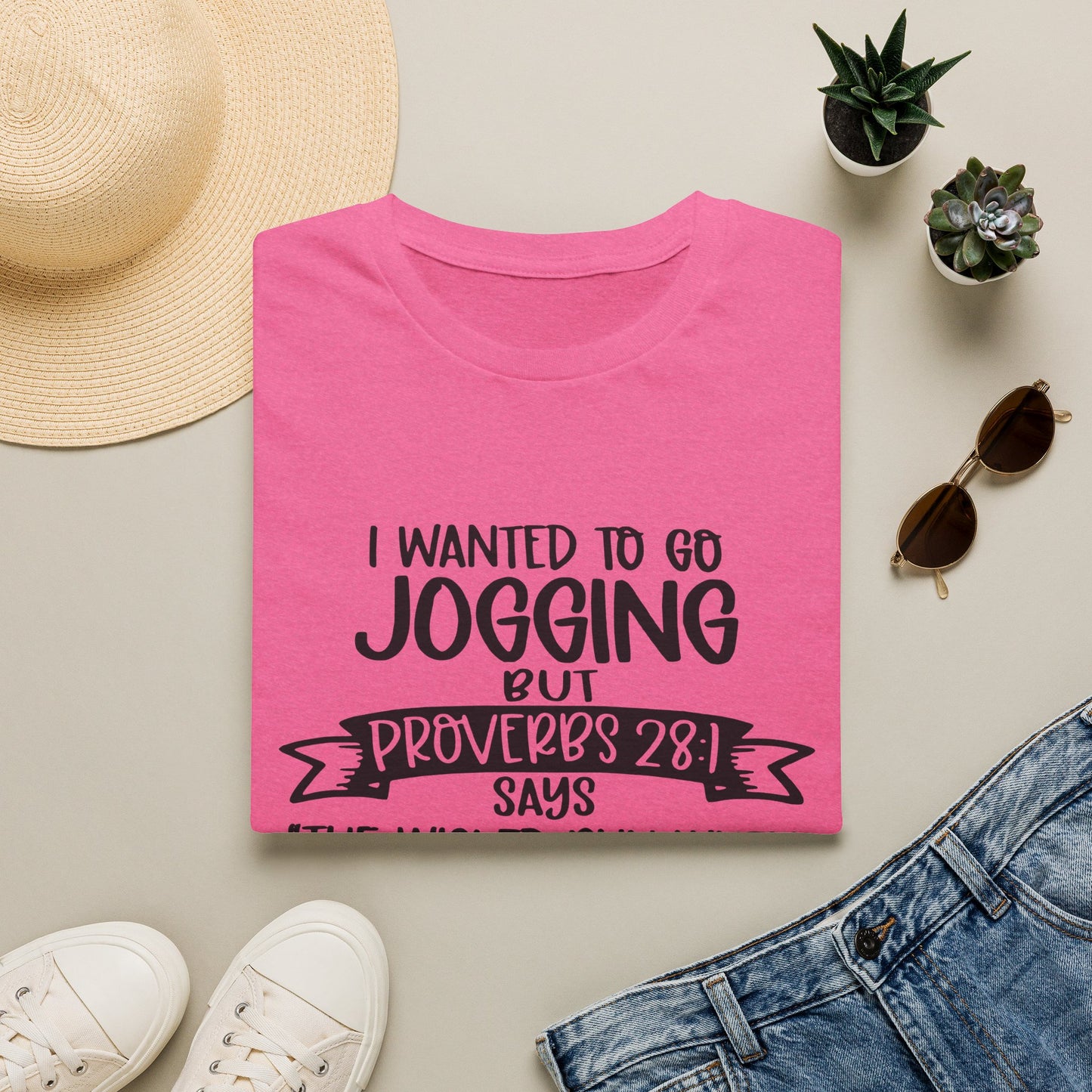 a pink t-shirt with a humorous text, a pair of jeans, sunglasses, a hat, and some potted plants arranged on a flat surface.