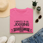 a pink t-shirt with a humorous text, a pair of jeans, sunglasses, a hat, and some potted plants arranged on a flat surface.