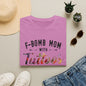 a pink t-shirt with the text "F-BOMB MOM WITH Tattoos" printed on it, along with a pair of jeans, sunglasses, and a straw hat.