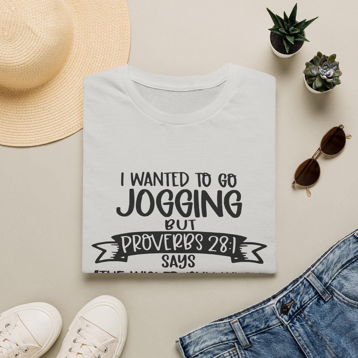 a white t-shirt with a humorous text printed on it, along with some casual clothing and accessories such as sunglasses, a hat, and a pair of sneakers.