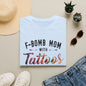 a white t-shirt with the text "F-BOMB MOM WITH TATToos" printed on it, along with a pair of jeans and sunglasses.