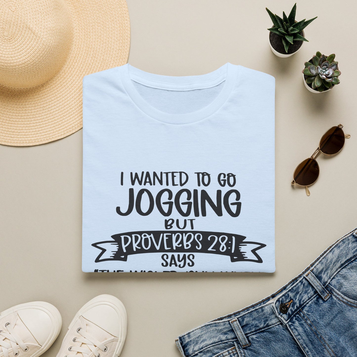 a white t-shirt with a humorous text printed on it, along with some casual clothing and accessories such as sunglasses, a hat, and a pair of sneakers.