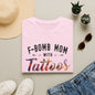 a pink t-shirt with the text "F-BOMB MOM WITH TATToos" printed on it, along with a pair of jeans, sunglasses, and a straw hat.