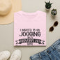a pink t-shirt with a humorous text, a pair of jeans, sunglasses, a hat, and some potted plants arranged on a flat surface.