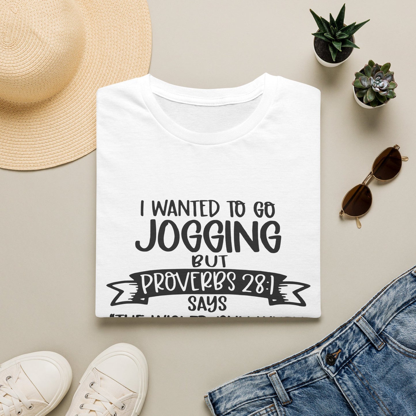 a white t-shirt with a humorous text printed on it, along with a pair of jeans, sunglasses, a hat, and some potted plants.