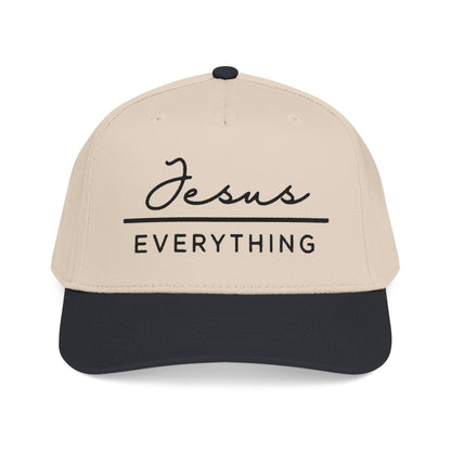 A beige baseball cap with the text "Jesus Everything" printed on it in black.