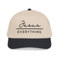 A beige baseball cap with the text "Jesus Everything" printed on it in black.