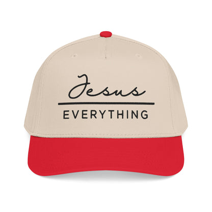 A beige baseball cap with a red brim, featuring the text "Jesus Everything" printed on it.