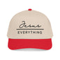 A beige baseball cap with a red brim, featuring the text "Jesus Everything" printed on it.