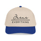 A beige baseball cap with a blue brim, featuring the text "Jesus Everything" printed on it.